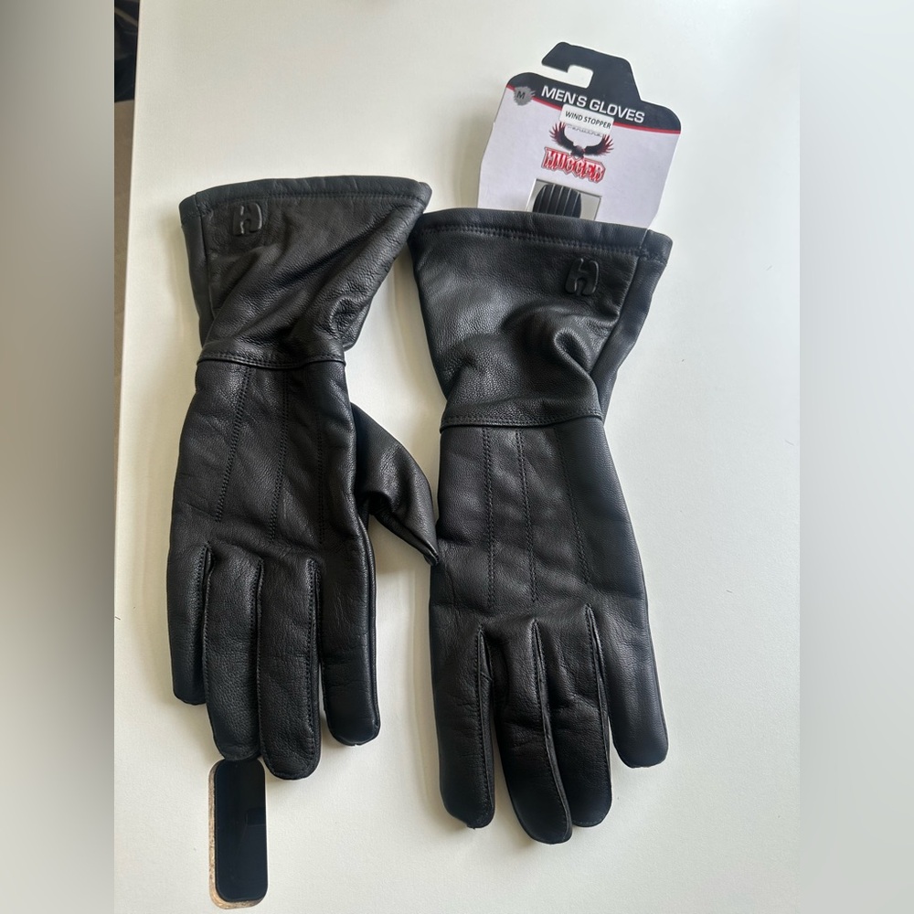 Brand new. Tags attached. 
Two pairs of Mens wind stopper hugger leather gloves